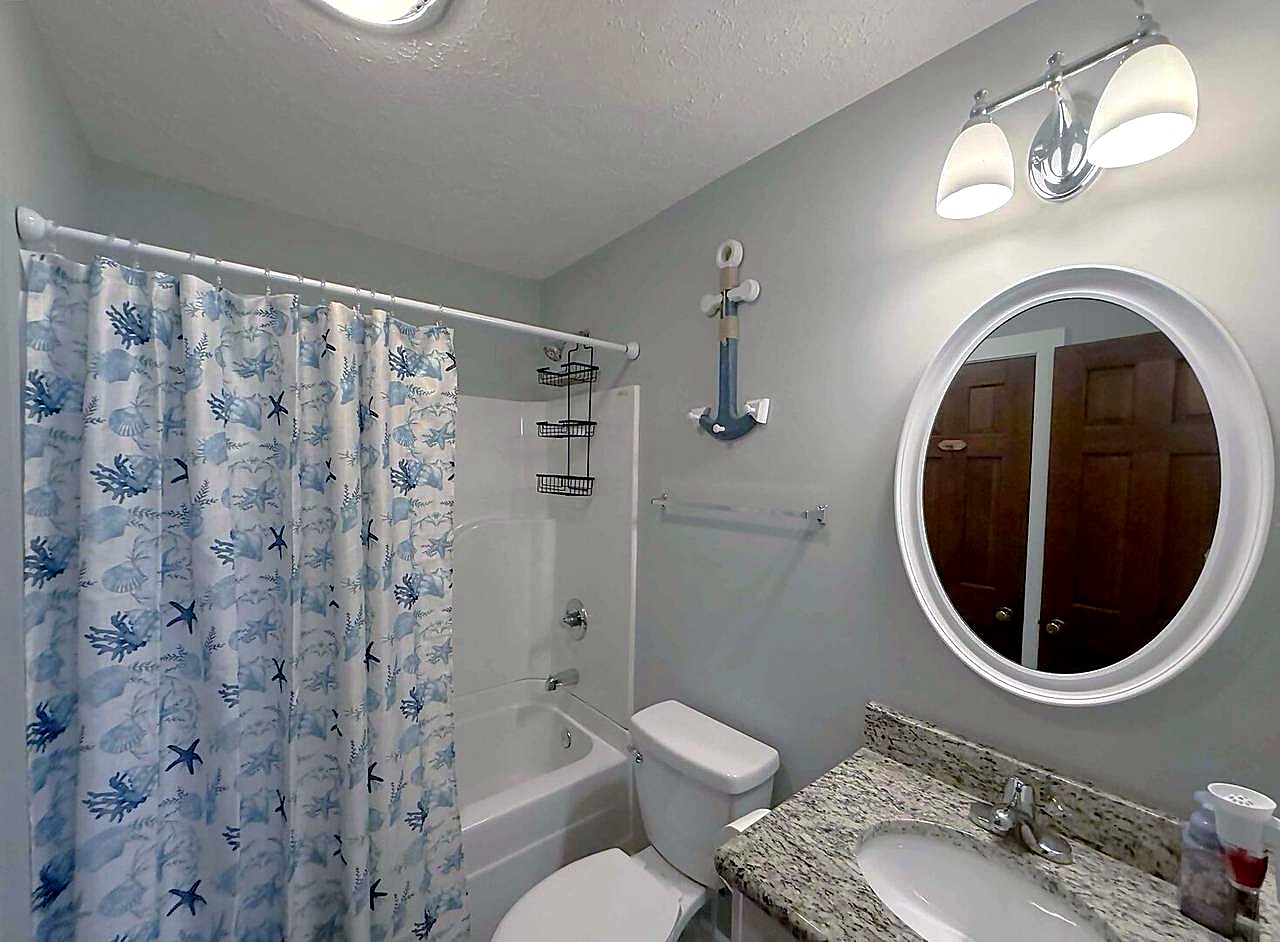 Second full bathroom with a tub and shower